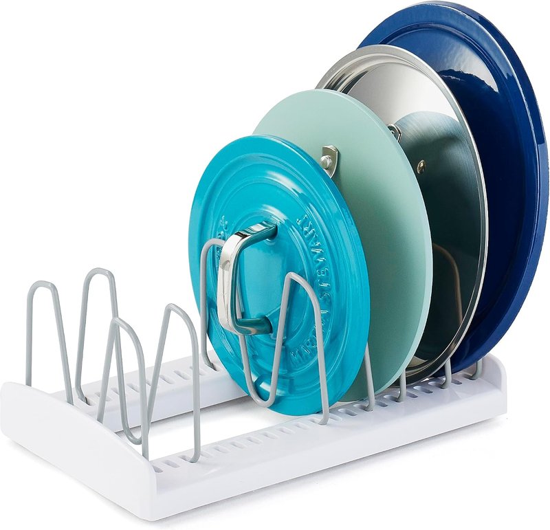 White lid rack holding several colored pot lids upright